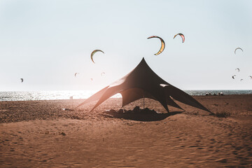 Colored tent for kite surfers on the sandy shores of the sea