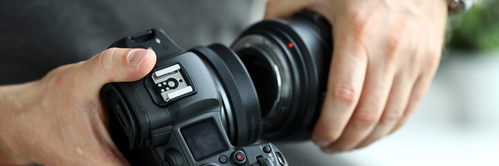 Sticker - Male hands putting on modern digital camera professional lens