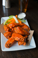 Wall Mural - Chicken wings, classic american style bar/pub favorite fare: chicken wings served spicy buffalo and honey barbecue. Paired with classic ranch and blue cheese dipping sauce. 