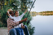 © cherryandbees - grandfather and his grandson fishing on the lake