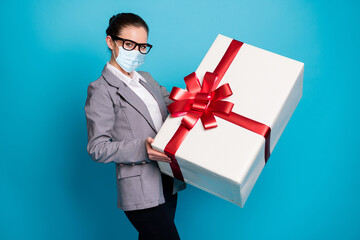 Sticker - Photo of positive girl lawyer receive big huge gift box wear mask grey blazer jacket isolated over blue color background