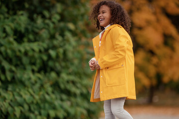 Wall Mural - Adorable little girl outdoors at beautiful autumn day