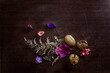 fall beautiful and vibrant colors with foliage purple dried leaves and cracked wallnuts on a dark background flat lay
