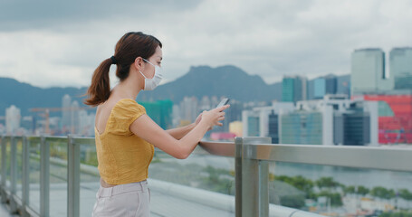 Poster - Woman wear face mask and use of mobile phone in city