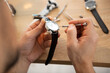 the watchmaker is repairing the mechanical watches in his workshop