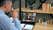 © viacheslav - Smiling smart woman teacher tutor trainer in laptop screen by remote web cam, distance education. Man student at home office studying online by conference video call computer, drinking coffee tea