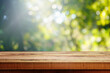 Wooden table and blurred green nature bokeh background for product.