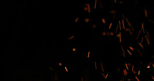 Background Of Feint Blurred Orange Sparks From Fire Against Black With Copyspace