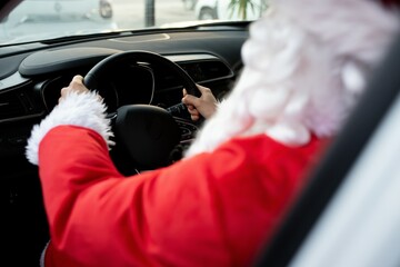 Authentic Santa Claus driving his modern car, outdoors