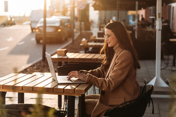 Wall Mural - Successful businessman working at laptop. Business woman working. Sales woman working using her laptop while writing text. Businesswoman in glasses working on-line. Mobile technology.