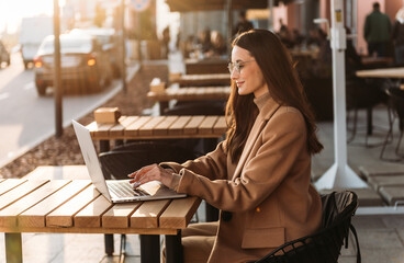 Wall Mural - Successful businessman working at laptop. Business woman working. Sales woman working using her laptop while writing text. Businesswoman in glasses working on-line. Mobile technology.