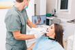 © Astarot - The dentist scans the patient's teeth with a 3d scanner.