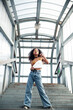 © iordani - young cute teenage african girl in industrial zone happy smiling having fun, big city lifestyle fashion people