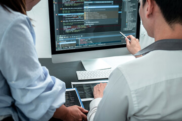 Wall Mural - team of developer programmer working on coding program software computer in office, writing website 