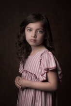 Classic Studio Portrait Of A Young Girl In Vintage Dress In Dark Painterly Rembrandt Style