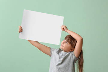 Wall Mural - Little girl with blank paper sheet on color background