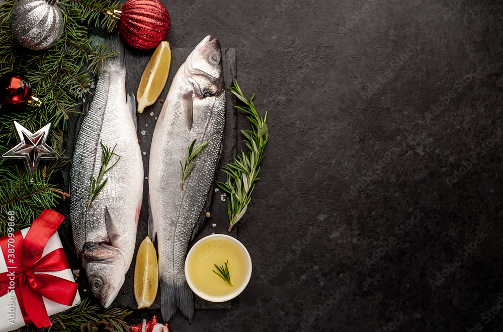 Raw sea bass fish with spices for the Christmas holiday on a stone ...