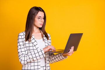 Wall Mural - photo portrait of concentrated woman working on computer wearing spectacles suit isolated on vibrant
