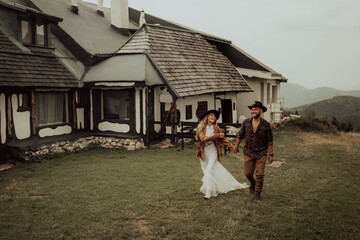 Loving couple on a  ranch in the western mountains in the autumn season. Elopement concept