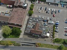 Aerial View Of Small Shopping Precinct And Car Park 