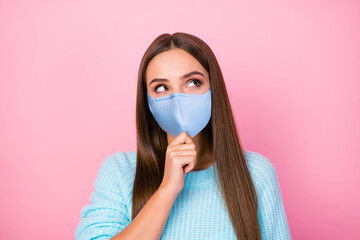 Poster - Photo of lady dreamer look up empty space hand on chin wear mask knitted blue sweater isolated pastel pink color background