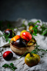 Fresh, ripe, organic tomatoes in an old basket. Rustic style