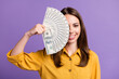© deagreez - Photo of charming young lady hold fan cash cover hide eye wear yellow shirt isolated purple color background