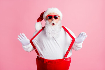 Poster - Photo of astonished overweight santa claus impressed tradition x-mas christmas shopping sales news pull suspenders wear headwear overalls sunglass isolated pink color background