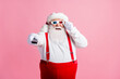 © deagreez - Portrait of his he nice attractive cheerful cheery guy Santa watching series show switching channel enjoying free time pastime amusement touching 3d specs isolated pink pastel color background