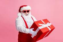 Photo Of Big Belly Fat Santa Claus Enjoy X-mas Night Christmas Event Celebration Hold Big Gift Box Wear Headwear Sunglass Suspenders Overall Isolated Over Pastel Color Background