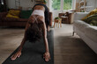 © Prins Productions - African American female teen in yoga position practising and stretching in modern lounge