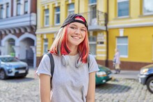 Portrait Of Fashionable Hipster Teenage Girl With Colored Dyed Hair In Black Cap