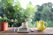 Bamboo Wooden Tea Cup And Yellow Tea Pot And Notebook And Plant Pot
