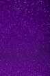 Abstract violet purple blurred sparkling background with focused area. Holiday festive concept. Glitter confetti. Christmas lights. 