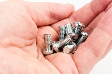 metal steel bolts in hand isolated on white background