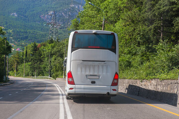 Wall Mural - Tourist bus moves along a suburban highway