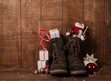 Fototapeta  - Leather boots with christmas treats and presents