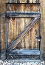 Old Wooden Barn Door With A Z Shaped Cross Beam And Padlock
