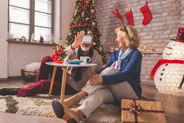 Wall Mural - Senior couple having video call with children on Christmas day