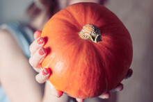 Girl Manicure Holding Autumn Pumpkin Pumpkin Day Halloween Party. Autumn Comfort Concept