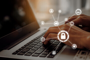 Business, technology, internet and networking concept. Young businesswoman working on his laptop in the office, select the icon security on the virtual display.