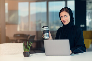 Wall Mural - professional young muslim business woman using mobile digital tablet computer at work