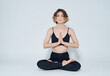 © SHOTPRIME STUDIO - Woman meet legs sitting on the floor meditation yoga asana