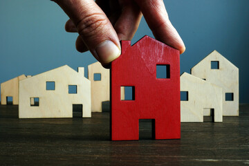 Sticker - Hand holds house. Choosing property or real estate assessment.