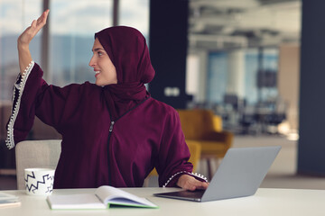 Wall Mural - professional young muslim business woman using mobile digital tablet computer at work