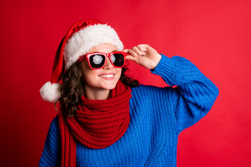 Close-up portrait of her she nice attractive pretty glad cheerful cheery dreamy girl wearing festal look warm clothes touching specs isolated bright vivid shine vibrant red color background