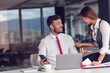 © FS-Stock - Couple of busy colleagues working together in modern office