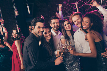 Poster - Photo of cheerful attractive people hold wineglass clink look camera wear stylish outfit modern club indoors