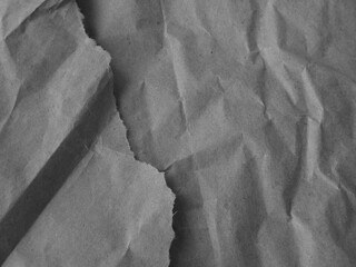 Black white background. Crumpled paper texture. Wrinkled torn paper. Gray rough background. Copy space for your design or product.