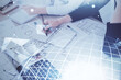 © peshkova - Multi exposure of hands making notes with world map hologram and data theme icons. Concept of global computer data.